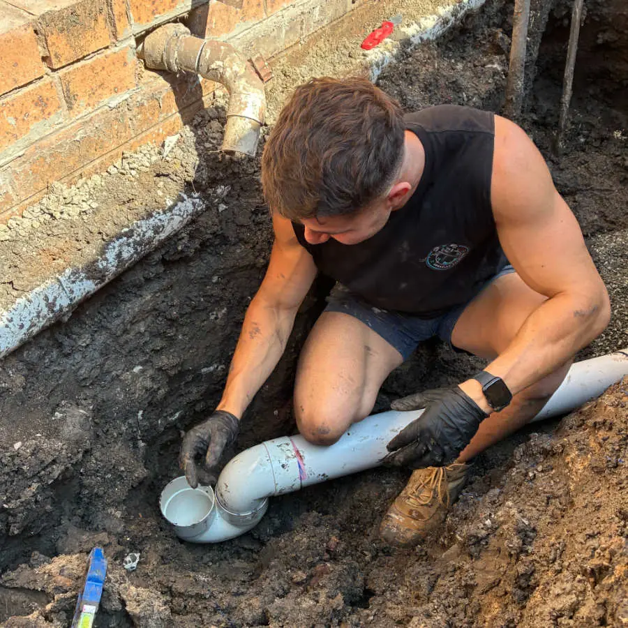 Yianni joining new PVC pipe in a trench